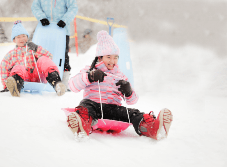 Kids sliding down a hill