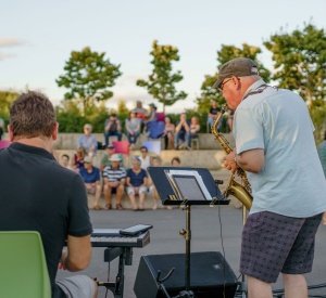 Man playing a saxophone at Victoria Park duirng Acoustica