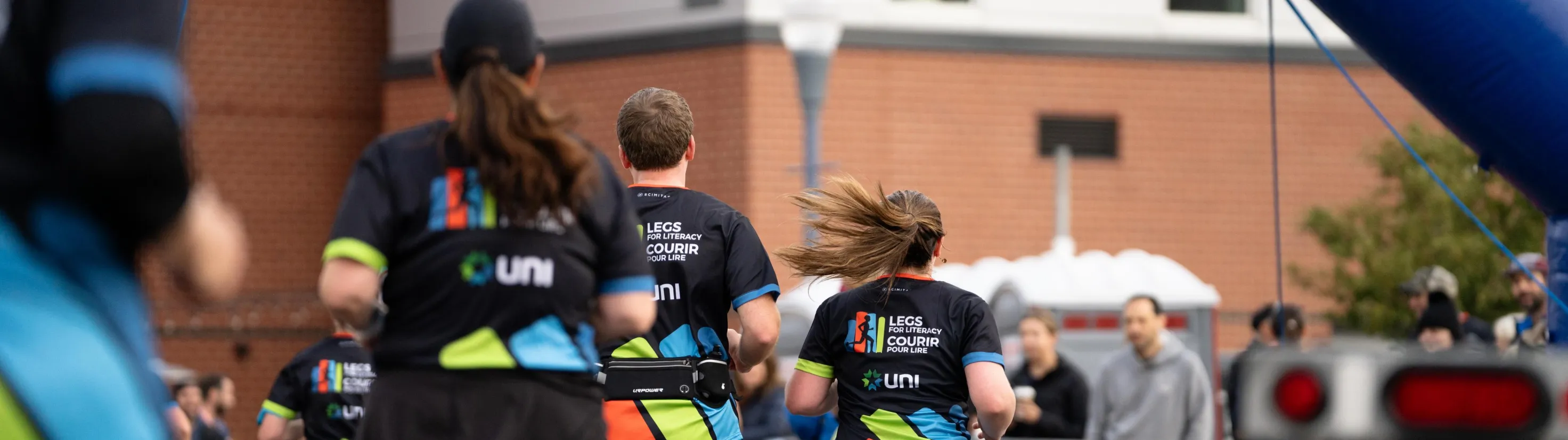 A group of runners racing toward the Legs for Literacy finish line. 