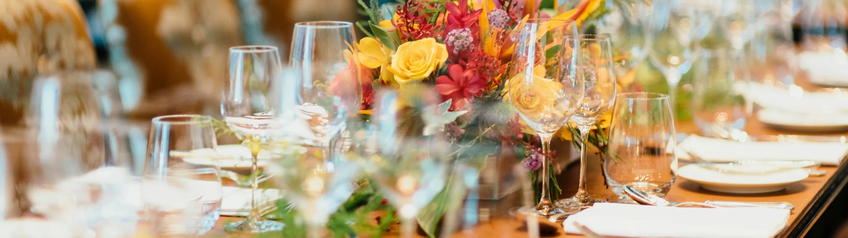 A table set for a special occasion with a floral centrepiece
