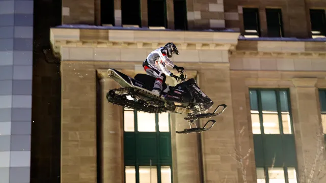 Athlete doing aerial tricks on a snowmobile