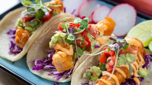 A row of soft-shelled fish tacos 