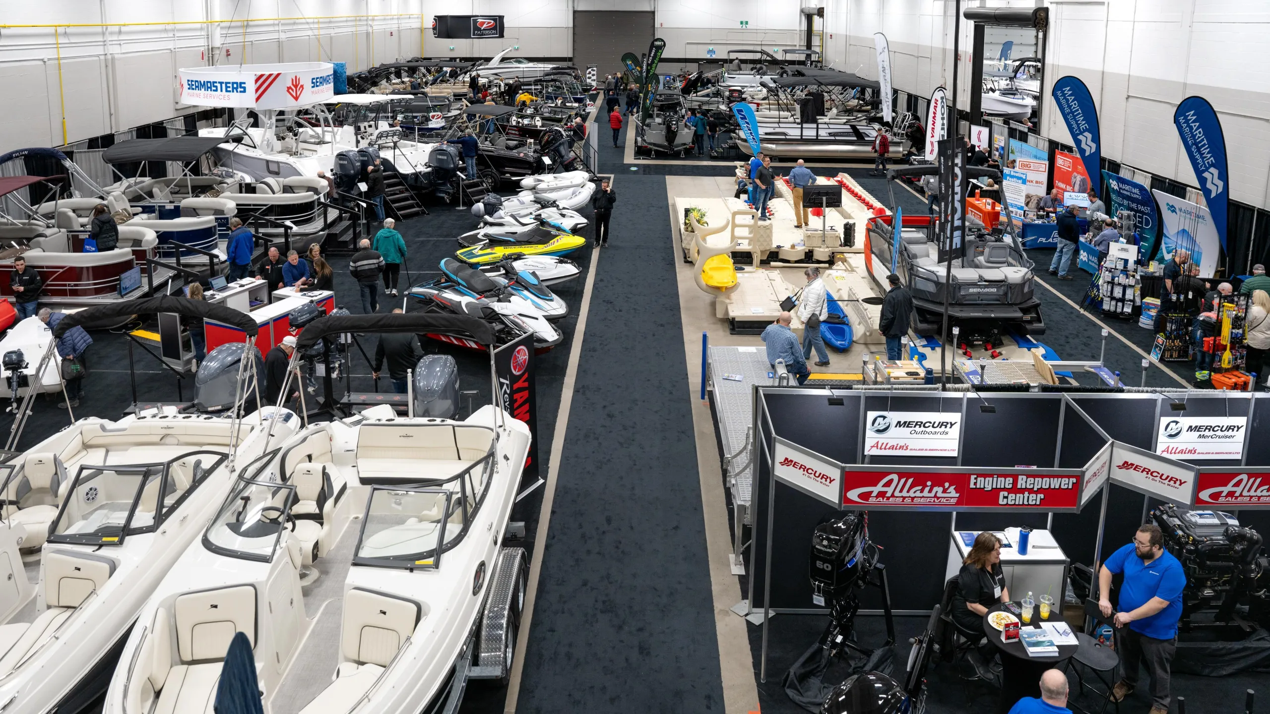 A view of a row of boats on a trade show floor