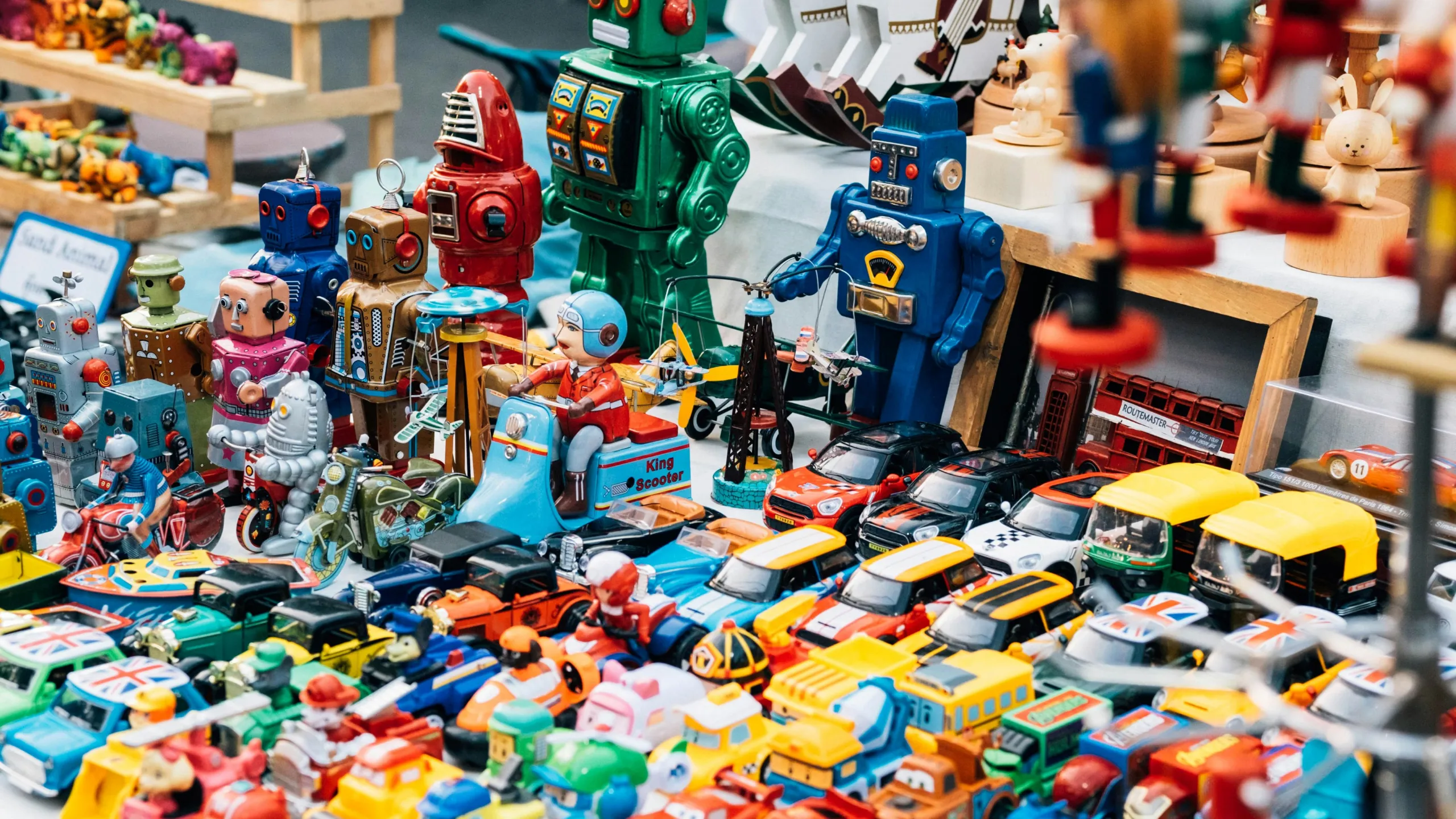 A colourful array of vintage and collectible toy cars, robots, and action figures. 