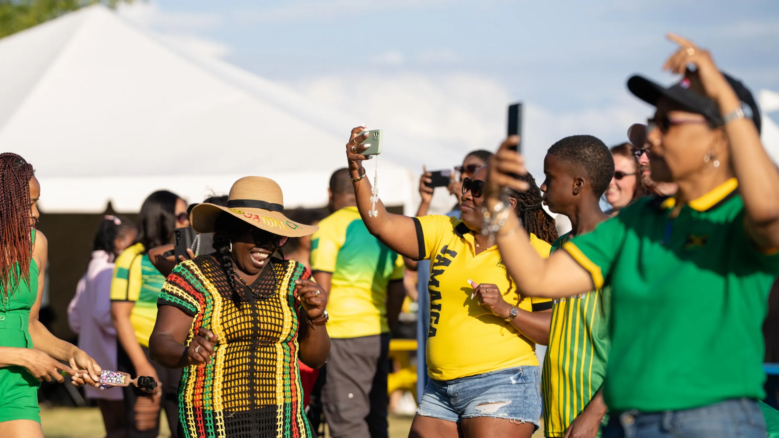 woman dancing in Jamaican flag colour