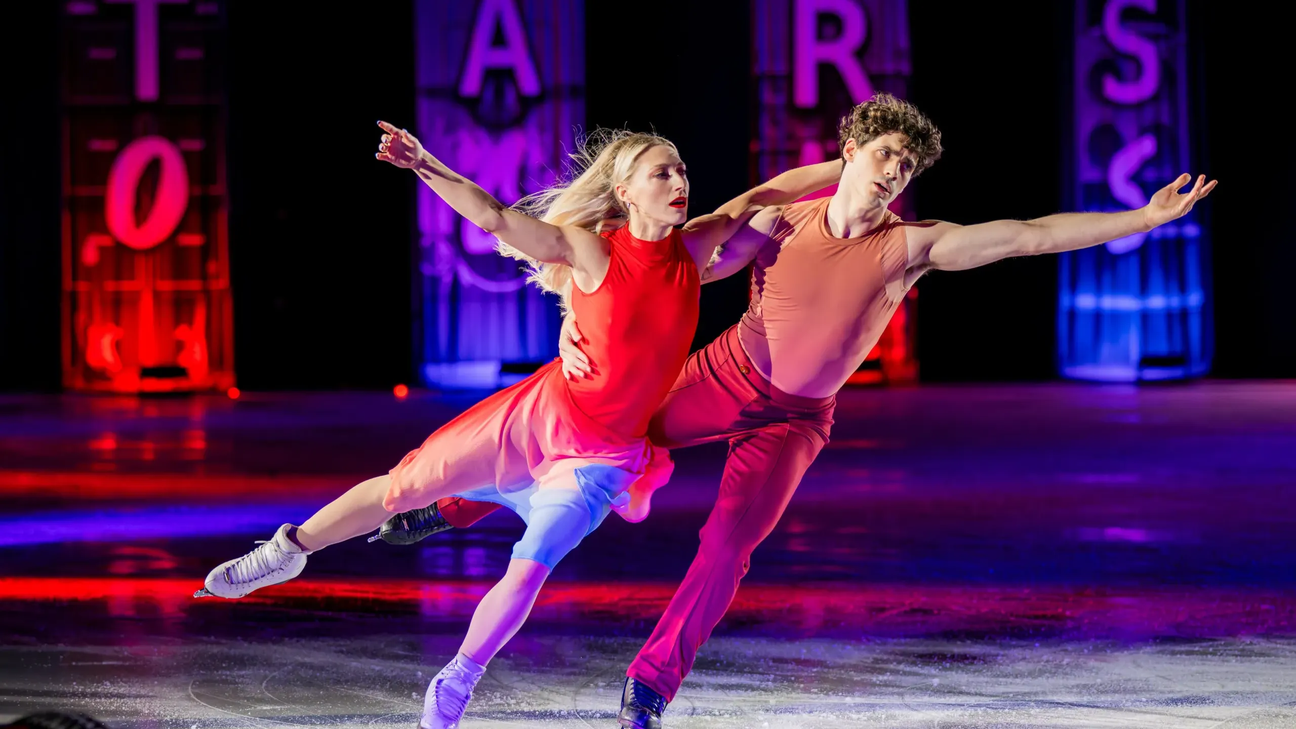 Piper Gilles and Paul Poirier skating together in costume