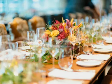 A table set for a special occasion with a floral centrepiece