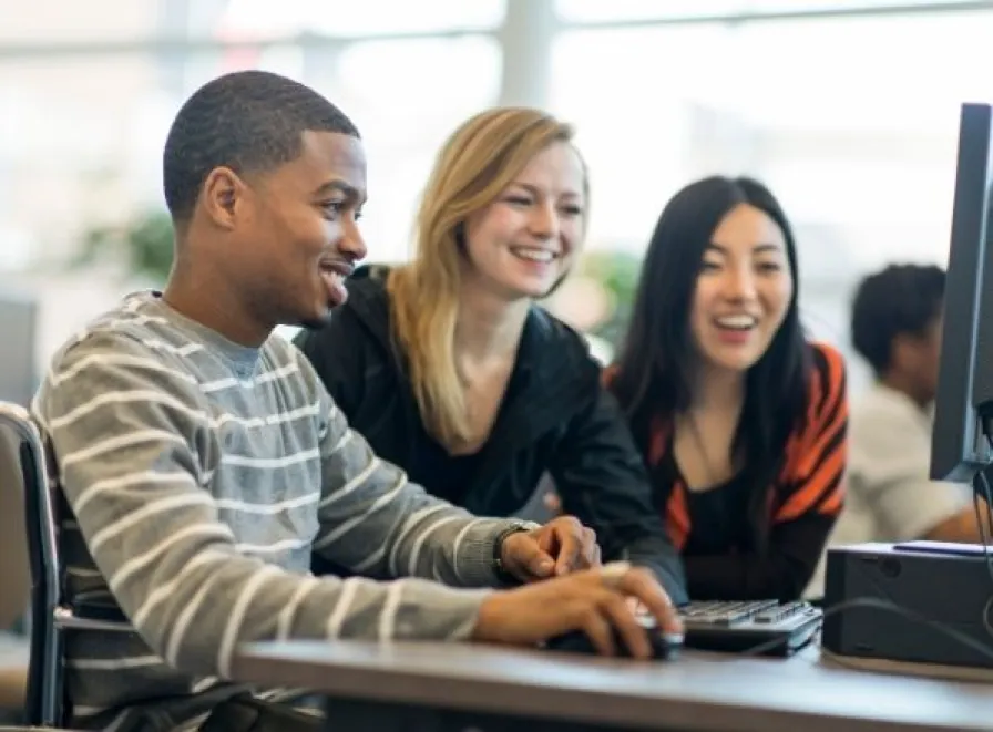 Students working around a computer